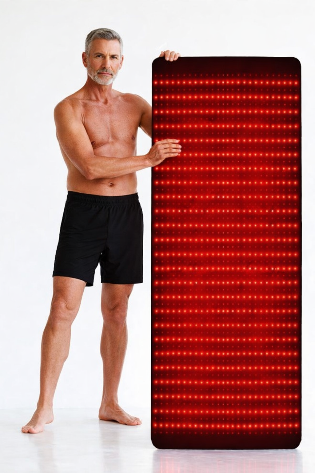 Man holding Lumi Mat™ full-body infrared light therapy mat by NanaVie on a white background